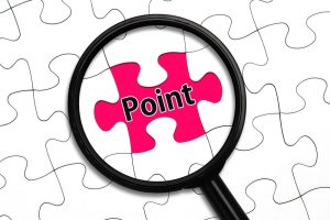 「Point」と書かれたパズルのピースにフォーカスしている虫眼鏡