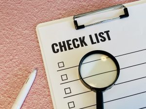 「CHECKLIST」と書かれたリスト表とそのうえに置かれた虫眼鏡